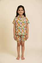 Young girl wearing a floral outfit on a beige background