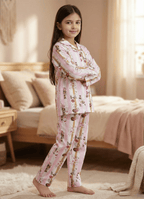 Young girl wearing pink floral pajamas in a bedroom setting