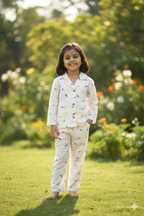 girl wearing honey hugs cream dino print linen co ord set outdoors